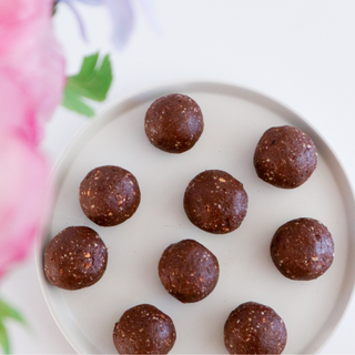 Freshly rolled chocolate honeycomb protein balls on a plate