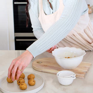 Freshly rolled Peaches and Cream Protein Balls made from Sneaky Wholefoods mix, a perfect plant-based, gluten-free, high-protein snack for a healthy lifestyle