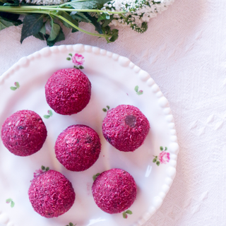 Cherry Delight Protein Balls on a decorative plate with floral patterns