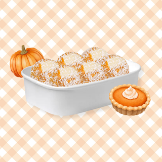 Pumpkin Pie Protein Balls in a white container showing chunks of white chocolate chips coated in coconut 