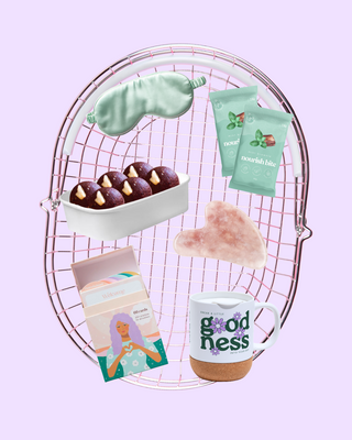 Collection of items including a mug with 'Goodness' text, cookies, and packets on a pink wire rack.