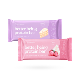 Two protein bars in wrapper packaging, one lavender purple labeled 'birthday cake' and one pink labeled 'strawberries & cream', shown on a clean white background.