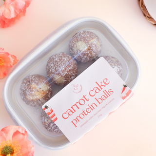 Packet of Sneaky Wholefoods carrot cake protein balls with a label on a light background