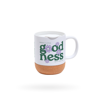 White mug with 'goodness' text and floral design on a white background