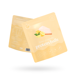 Image of a yellow Protein Ball Mix Packet with a lemon cheesecake illustration on it with Lemon Cheesecake written on it