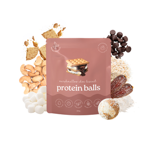 A stand-up pouch labeled 'protein balls' with marshmallow chocolate biscuit imagery, surrounded by snack ingredients including graham crackers, chocolate chips, cashews, dates, and marshmallows on a white background.