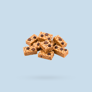 A cluster of rectangular peanut butter cookie sneaky seconds, floating against a solid light blue background.