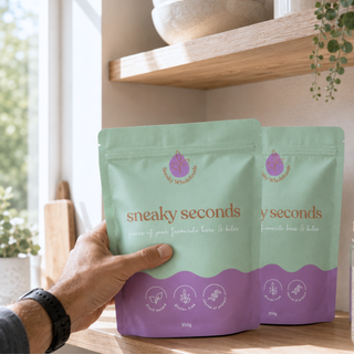 A packet of Sneaky Seconds on a kitchen shelf with a mans hand reaching for it 