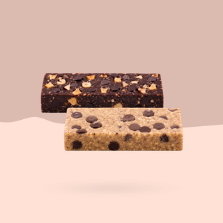 Two rectangular protein bars floating on a white background, one hazelnut chocolate and one  cookie dough 