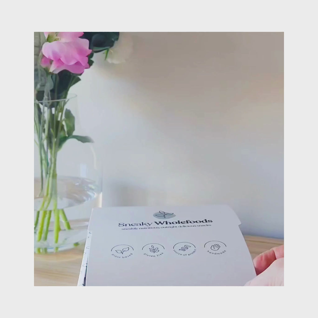 Sneaky Wholefoods Snacks being unboxed to showcase their range of protein bars and nourish bites designed to support your wellbeing