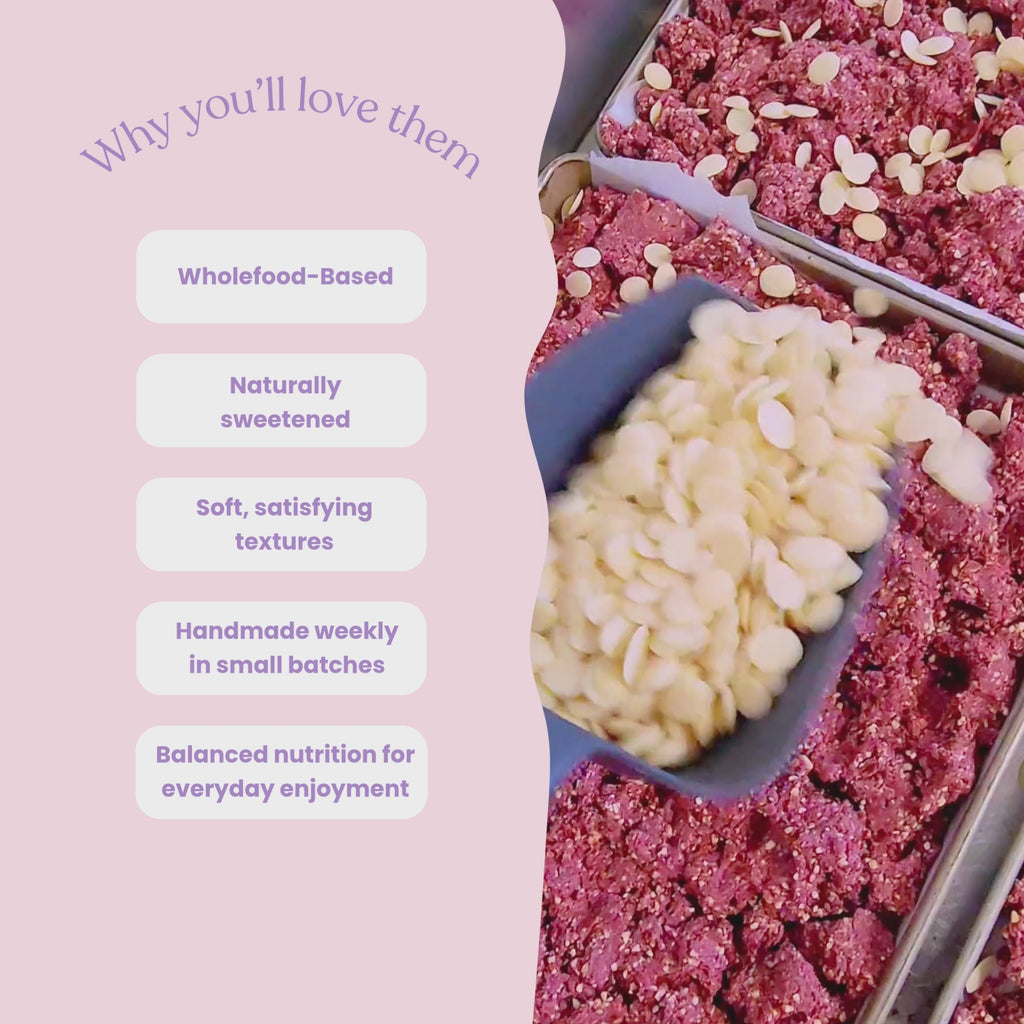 Video showcasing Sneaky Wholefoods Strawberries and Cream and Birthday Cake Protein Bars in a production setting, switching between different flavours while highlighting key features including wholefood-based ingredients, naturally sweetened, soft satisfying textures, handmade weekly in small batches, and balanced nutrition for everyday enjoyment.