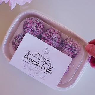 Chocolate Speckled Cake Pop Protein Ball packet being open and show eaten into