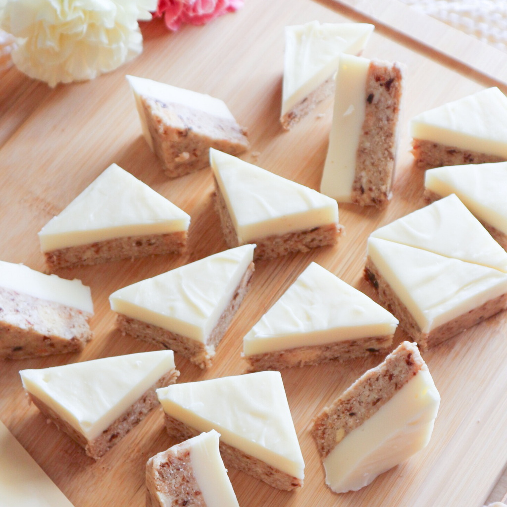 Lemon White Choc Fudge Slice being cut into triangles 