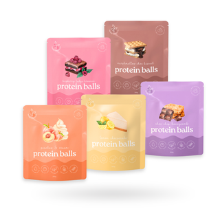 A image of 5 packets of protein ball mixes of all different colours and flavours: raspberry fudge brownie, marshmallow choc biscuit, peaches and cream, lemon cheesecake and choc chip honeycomb