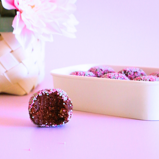 Chocolate Speckled Cake Pop Protein Ball half eaten to show what it looks like inside