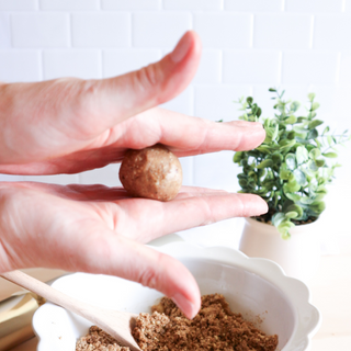 neaky Wholefoods Gingerbread Cookie Dough Protein Ball Mix being rolled into balls, capturing the ease of making Christmas-inspired protein snacks to enjoy during the holiday season.
