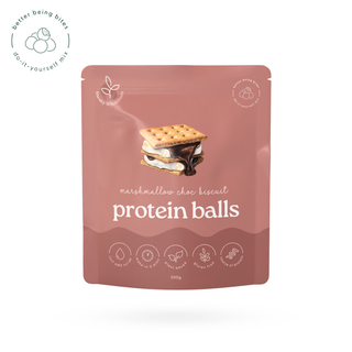 A stand-up pouch of marshmallow choc biscuit protein balls on a white background. The pouch is dusty pink with a central illustration of a chocolate-covered graham cracker and marshmallow sandwich, with the text 'marshmallow choc biscuit protein balls' in white.