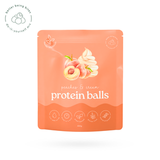 A stand-up pouch of protein balls with a peach and cream flavour illustration on the front, shown on a clean white background with a small circular logo in the top-left corner.