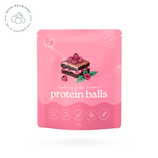 A pink stand-up pouch of protein balls with a raspberry fudge brownie flavour illustration on the front, shown on a white background with a small circular logo in the top-left corner.