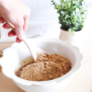 Sneaky Wholefoods Gingerbread Cookie Dough Protein Ball Mix contents being mixed in a bowl, an easy way to prepare your holiday-themed protein treats, ideal for Christmas snacking.