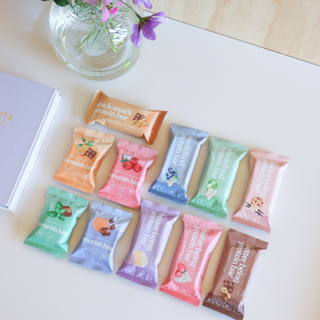 Sneaky Wholefoods Protein Bars and Nourish Bites on a desk, showcasing the positive impact of healthy snacking on focus, and mood
