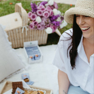 lady evoking happiness while snacking on sneaky wholefoods
