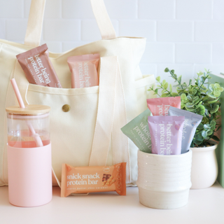 Sneaky Wholefoods protein bars neatly packed in a stylish handbag and jar, showcasing the convenience of the Weekly Bar Bundle for on-the-go snacking and fueling your busy week with wholesome energy.
